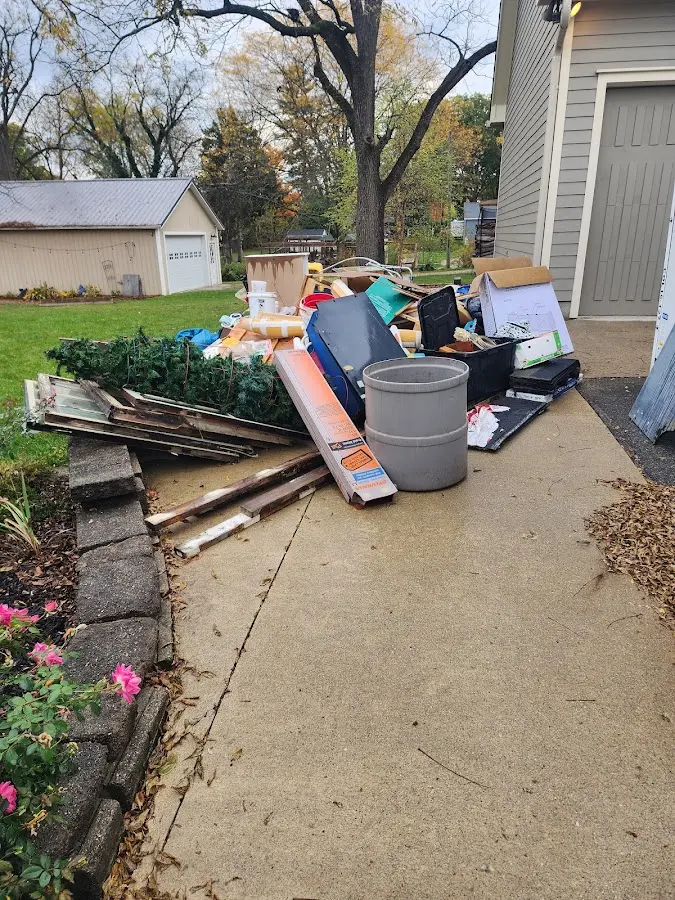 Dumpster being loaded with debris for Commercial Dumpster Rental in Hopkinton